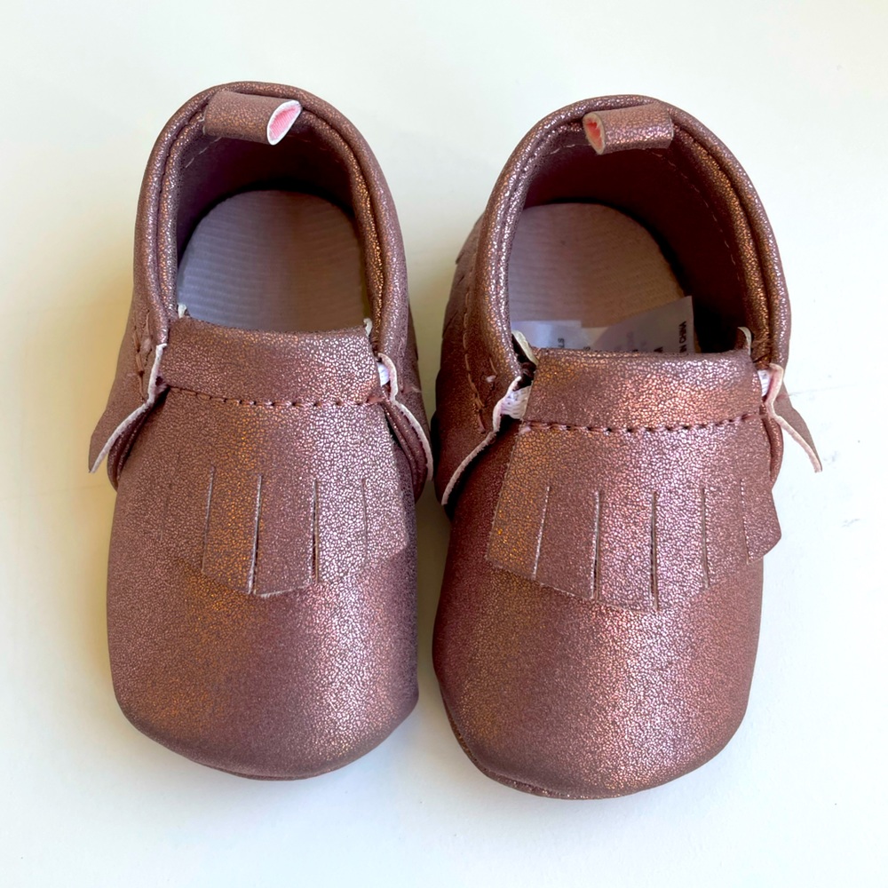 Baby rose gold moccasins.